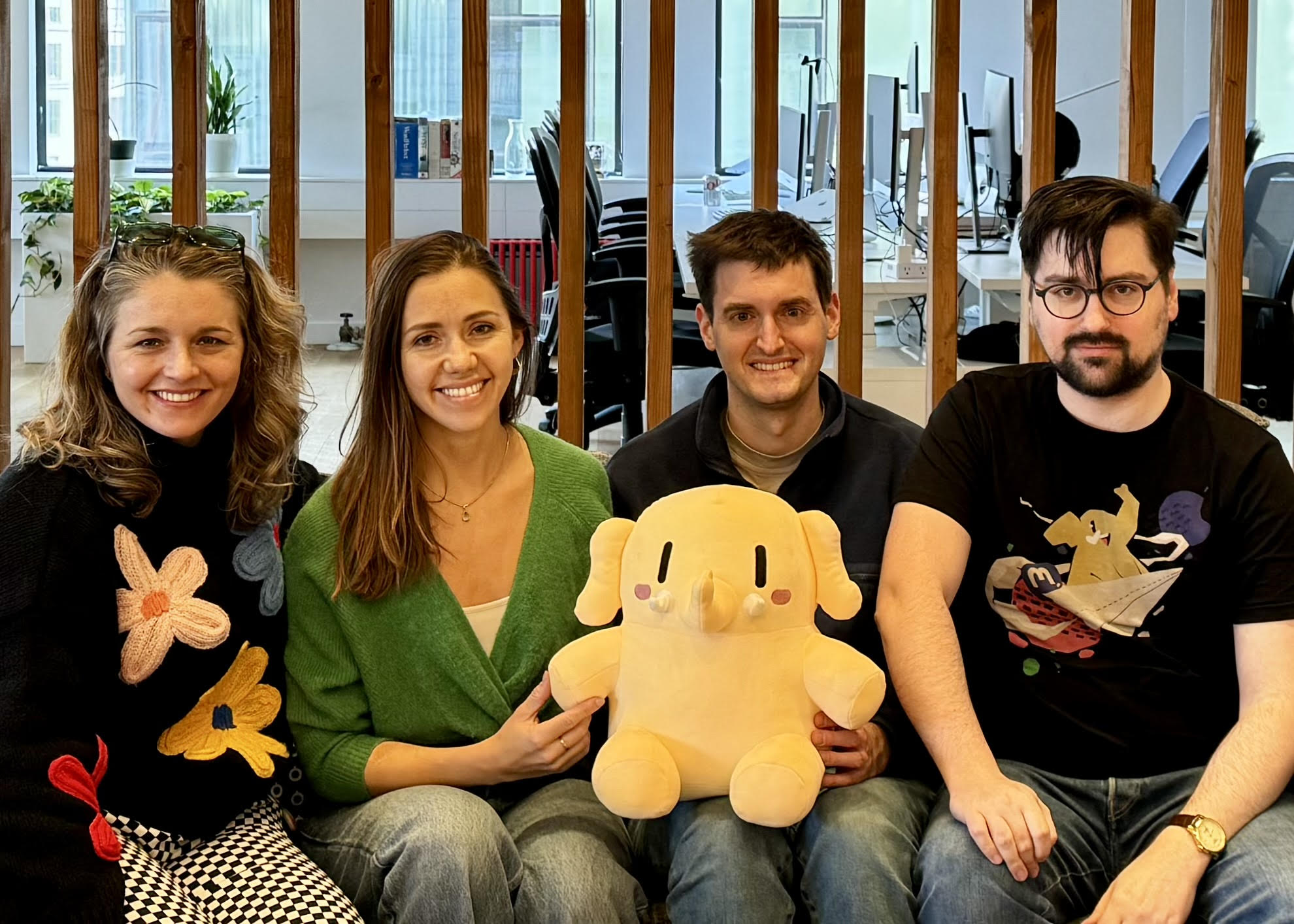 A photograph of some of the Mastodon team, with their mascot