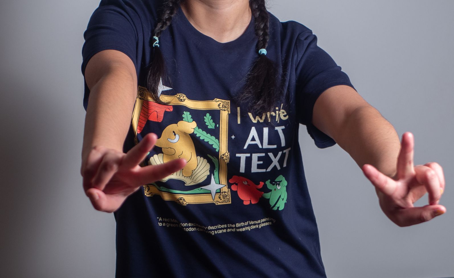 A photo of a person wearing a t-shirt with the slogan 'I write ALT text'