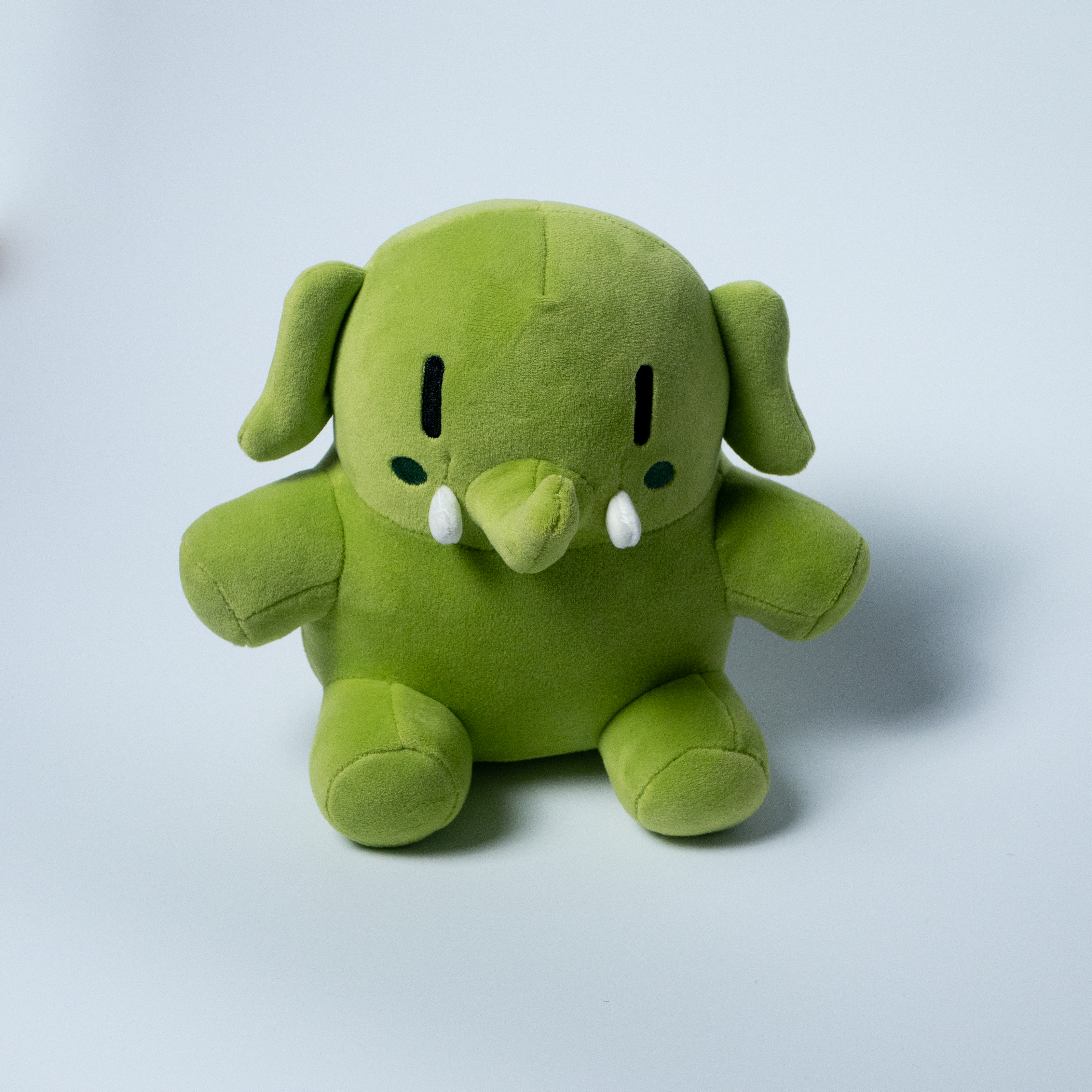 The green Mastodon plushie, face on