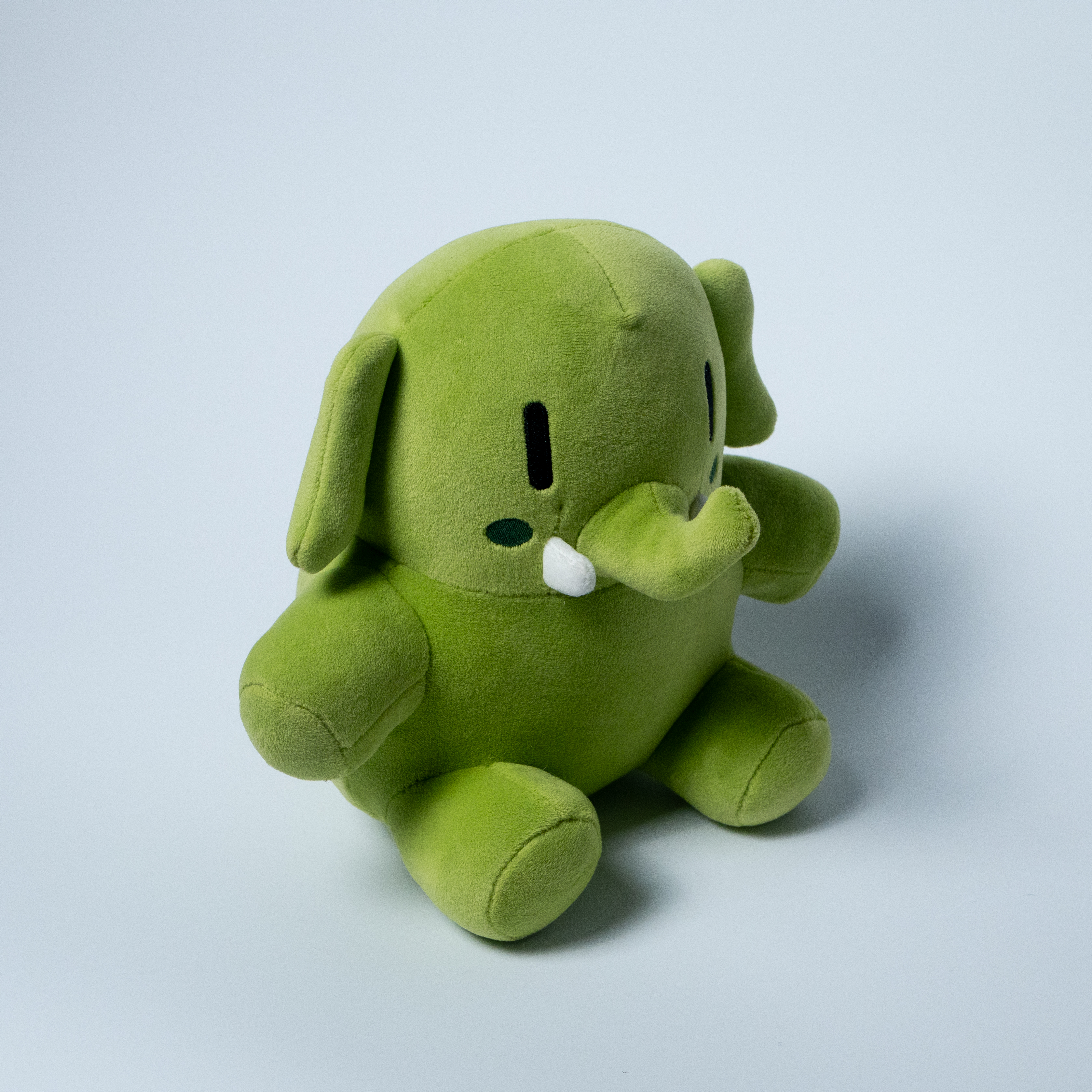 The green Mastodon plushie, turned a bit to the side