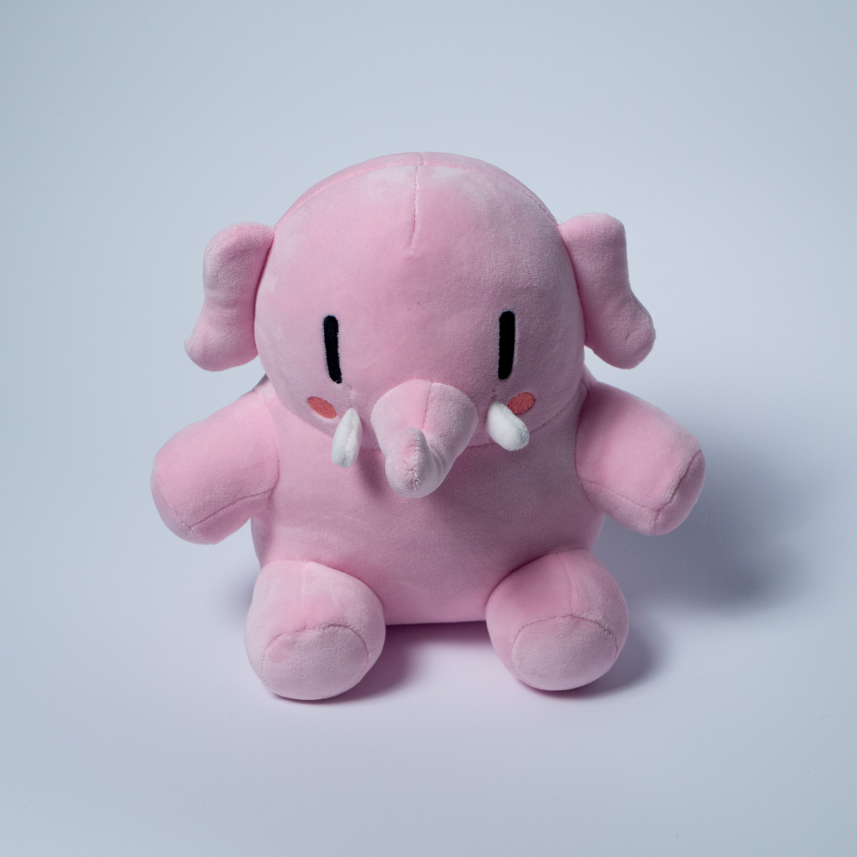 The pink Mastodon plushie, face on